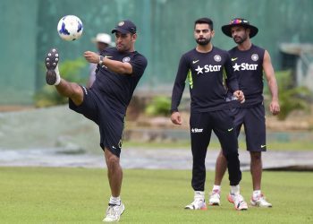 Indian cricket captain  Mahendra Singh Dhoni (L) plays football with his teammates Virat Kohli (C) and Shikhar Dhawan (R) during a practice session at the Sher-e-Bangla National Cricket Stadium in Dhaka on June 17, 2015, ahead of the first ODI (One Day International) cricke match against Bangladesh. AFP PHOTO/Munir uz ZAMAN        (Photo credit should read MUNIR UZ ZAMAN/AFP/Getty Images)