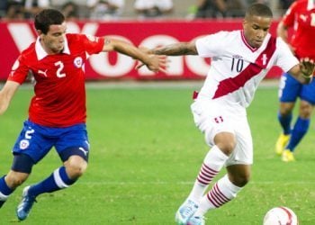 LIMA, PERU - MARCH 22:   Jefferson Farfan of Peru fights for the ball with Eugenio Mena of Chile during a match between Peru and Chile as part of the 11th round of the South American Qualifiers for the FIFA World Cup Brazil 2014 at the Estadio Nacional on March 22, 2013 in Lima, Peru. (Photo by Marco del Rio/LatinContent/Getty Images)