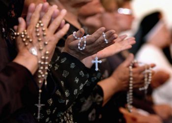 BAGHDAD, IRAQ - APRIL 7: Worshippers pray at a service for Pope John Paul II on April, 7, 2005 at a Catholic church in Baghdad, Iraq. Pope John Paul II died at his residence in the Vatican on April 2, aged 84 years old.  His funeral will be held in St. Peter's Square on Friday, April 8. Cardinals under the age of 80 will start the conclave on April 18, where a new Pope will be chosen. (Photo by Wathiq Khuzaie/Getty Images)