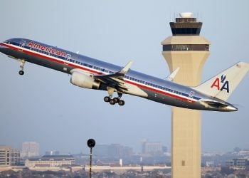 In this Jan. 15, 2015 photo, an American Airlines aircraft takes off from Dallas-Fort Worth International Airport, in Grapevine, Texas. American Airlines reports quarterly financial results on Tuesday, Jan. 27, 2015. (AP Photo/Tony Gutierrez)