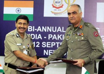 : Border Security Force (BSF) Director General DK Pathak and Pakistani Rangers Director General (Punjab), Major General Umar Farooq Burki shake hands after signing an agreement, at the end of the BSF-Pak Rangers Annual Meet at BSF headquarters in New Delhi on Saturday.Tribune photo.Mukesh Aggarwal