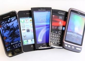 Leading Brands Of Smart Phones...A collection of smartphones, from left, a Samsung Galaxy S, an Apple Inc. iPhone 4, a Sony Ericsson Xperia X10, a Blackberry 9700, and an HTC Desire, are arranged for a photograph in London, U.K., on Wednesday, July 7, 2010. Global smartphone sales will rise 36 percent to 247 million in 2010, ISuppli Corp. said in April. Photographer: Chris Ratcliffe/Bloomberg