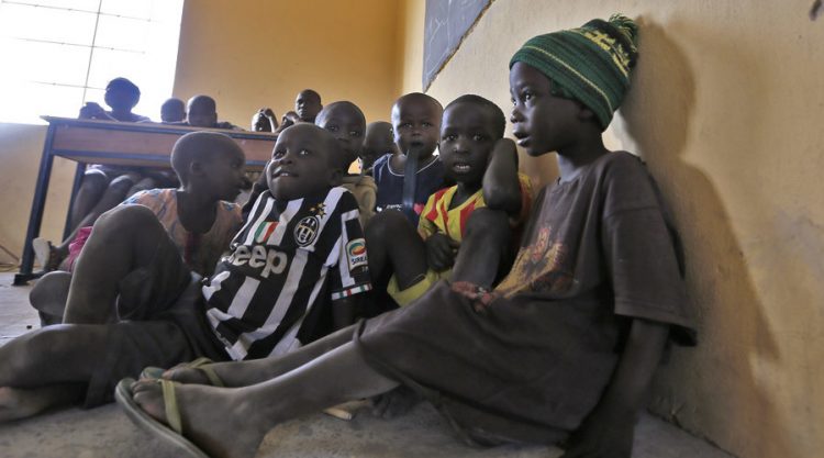 Children displaced as a result of Boko Haram attack in the northeast region of Nigeria, attend a class at Maikohi secondary school camp for internally displaced persons (IDP) in Yola, Adamawa State January 13, 2015. Boko Haram says it is building an Islamic state that will revive the glory days of northern Nigeria's medieval Muslim empires, but for those in its territory life is a litany of killings, kidnappings, hunger and economic collapse. Picture taken January 13, 2015. To match Insight NIGERIA-BOKOHARAM/     REUTERS/Afolabi Sotunde (NIGERIA - Tags: CIVIL UNREST SOCIETY EDUCATION) - RTR4M2ST