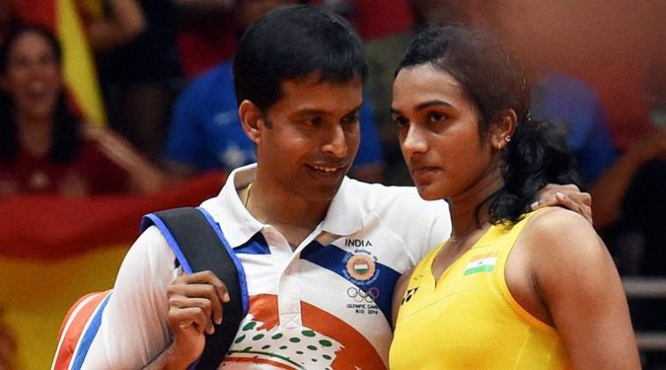 Rio de Janeiro: India's Pusarla V Sindhu with coach Pullela Gopichand after she lost against Spain's Carolina Marin in women's Singles final at the 2016 Summer Olympics at Rio de Janeiro in Brazil on Friday. PTI Photo by Atul Yadav (PTI8_19_2016_000310b)