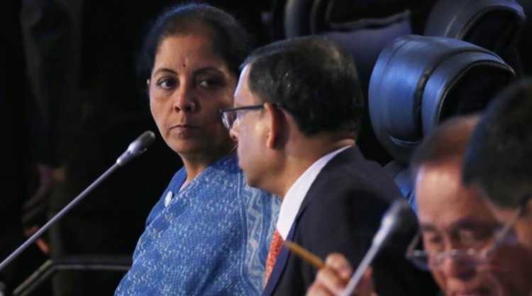 Indian Defense Minister Nirmala Sitharaman, left, sits with an unidentified official as she takes part in the two-day ASEAN Defense Ministers' Meeting and its Dialogue Partners Tuesday, Oct. 24, 2017 at Clark, Pampanga province, north of Manila, Philippine. (AP Photo/Bullit Marquez)