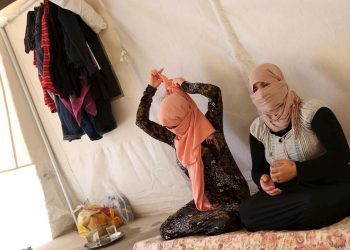 Yazidi sisters, who escaped from captivity by Islamic State (IS) militants, sit in a tent at Sharya refugee camp on the outskirts of Duhok province July 3, 2015. The sisters were among one hundred women, men and children taken by IS as prisoners after the militants attacked their village of Tal Ezayr in the northern Iraqi province of Mosul close to Syrian border last year. In an interview with Reuters TV, the sisters talked about their horrific ordeal, treatment of women by the militants, and their eventual escape. Picture taken July 3, 2015. REUTERS/Ari Jala - RTX1LE9W