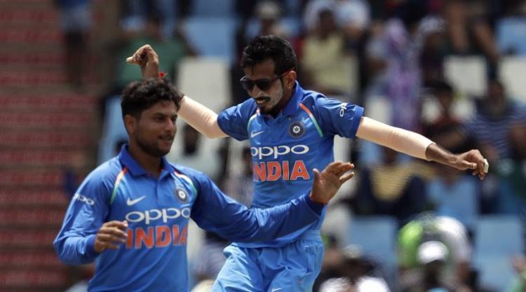 India's bowler Kuldeep Yadav, left, celebrates with teammate Yuzvendra Chahal after taking a third wicket of South Africa's batsman Kagiso Rabada, during the second One Day International cricket match between South Africa and India at Centurion Park in Pretoria, South Africa, Sunday, Feb. 4, 2018. (AP Photo/Themba Hadebe)