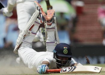 India's batsman Cheteshwar Pujara dives unsuccessfully to avoid a run out by South Africa's fielder Lungi Ngidi during the second day of the second cricket test match between South Africa and India at Centurion Park in Pretoria, South Africa, Sunday, Jan. 14, 2018. (AP Photo/Themba Hadebe)