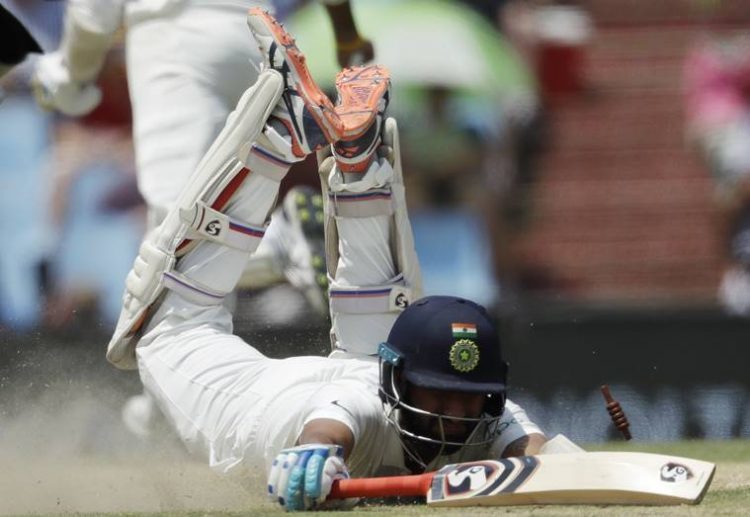 India's batsman Cheteshwar Pujara dives unsuccessfully to avoid a run out by South Africa's fielder Lungi Ngidi during the second day of the second cricket test match between South Africa and India at Centurion Park in Pretoria, South Africa, Sunday, Jan. 14, 2018. (AP Photo/Themba Hadebe)