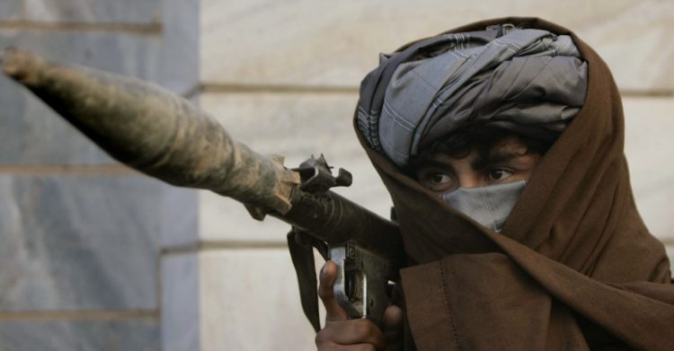 A former Taliban fighter carries a rocket launcher before surrendering it to Afghan authorities in Herat, west of Afghanistan, Sunday, Dec 5, 2010.(AP Photo/Reza Shirmohammadi)