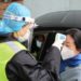 A security officer in a protective mask checks the temperature of a passenger following the outbreak of a new coronavirus, at an expressway toll station on the eve of the Chinese Lunar New Year celebrations, in Xianning, a city bordering Wuhan to the north, Hubei province, China January 24, 2020. REUTERS/Martin Pollard