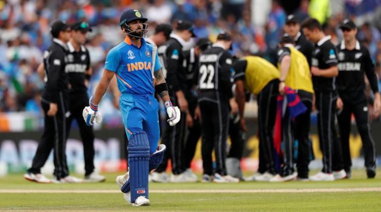 Cricket - ICC Cricket World Cup Semi Final - India v New Zealand - Old Trafford, Manchester, Britain - July 10, 2019   India's Virat Kohli reacts after losing his wicket   Action Images via Reuters/Lee Smith