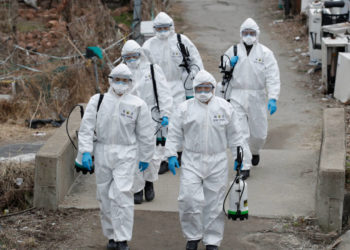 South Korean soldiers wearing protective gears walk to spray disinfectant as a precaution against the new coronavirus in Seoul, South Korea, Tuesday, March 3, 2020. China's coronavirus caseload continued to wane Tuesday even as the epidemic took a firmer hold beyond Asia. (AP Photo/Lee Jin-man)