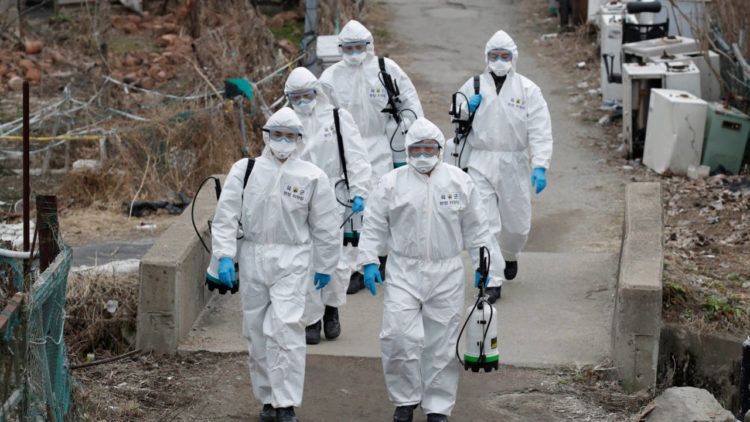 South Korean soldiers wearing protective gears walk to spray disinfectant as a precaution against the new coronavirus in Seoul, South Korea, Tuesday, March 3, 2020. China's coronavirus caseload continued to wane Tuesday even as the epidemic took a firmer hold beyond Asia. (AP Photo/Lee Jin-man)