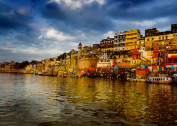 big wooden boats in water with cloudy sky and sunbeams at allahabad indian asia