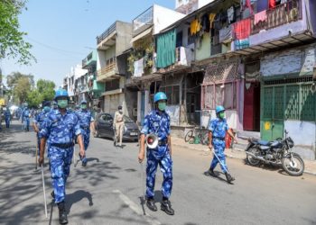 Security personnel wearing facemasks patrol on a deserted street during a government-imposed nationwide lockdown as a preventive measure against the COVID-19 coronavirus, in Ahmedabad on April 11, 2020. (Photo by SAM PANTHAKY / AFP)