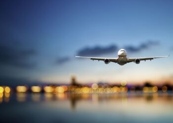 perspective view of jet airliner in flight with bokeh background
