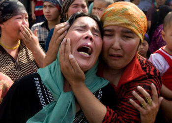 Uigher  women grieving for their men who they claim were taken away by the Chinese authorities after Sunday's protest in Urumqi, China, Tuesday, July 7 , 2009. (AP Photo/Ng Han Guan)